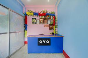a desk in a room with an ovo sign on it at spot On Happy Awashi Hotel in Patna City