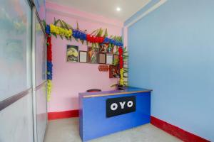 a blue podium with an ovo sign on it in a room at spot On Happy Awashi Hotel in Patna City