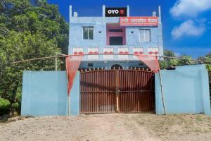 a building with a gate in front of it at spot On Happy Awashi Hotel in Patna City
