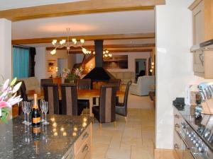 a kitchen and dining room with a dining table at Orchard House in Parkham