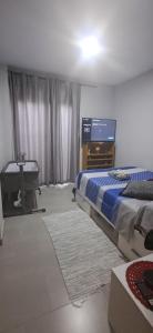 a bedroom with a bed and a flat screen tv at COMODIDADe in Colmenar Viejo