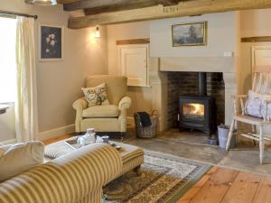 a living room with a couch and a fireplace at Westfield Farm Uk33124 in Kirby Misperton