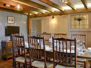 a dining room with a long table and chairs at Westfield Farm Uk33124 in Kirby Misperton