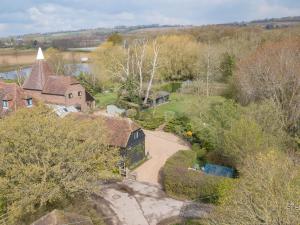 an aerial view of a house with a driveway at Woolhouse Barn in Hunton