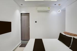 a bedroom with a bed and a door at Hotel O Royal Fourtune in Utrān