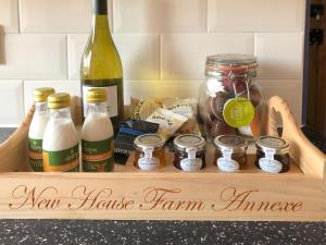 a wooden box with a bottle of wine and other ingredients at New House Farm Annexe in Neenton +7 photos