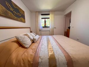 a bedroom with a large bed with two pillows on it at Quinta do Assento in Louredo +57 photos