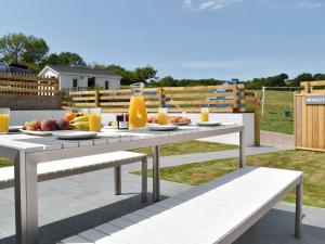 a picnic table with fruit on it on a patio at Brameley in Cheriton Bishop