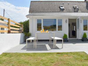 a table and two chairs in front of a house at Brameley in Cheriton Bishop