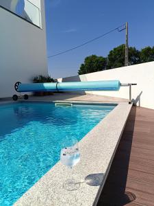 a swimming pool with a plastic bag in the water at Ikigai B&B in Carvalhal