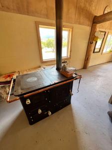 a stove in the middle of a room at Surí refugios Aquasol, Carretera Austral, Cochrane in Cochrane
