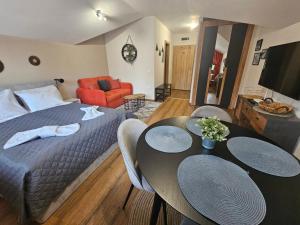a bedroom with a bed and a table and chairs at Rustic Mountain Apartment - A55 in Borovets