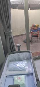 an empty bed in a room with a window at COMODIDADe in Colmenar Viejo