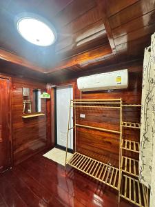 a room with wooden walls and a room with a heater at Peony brown in Thongsala
