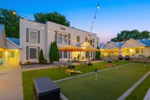 a house with a lawn with tables and umbrellas at Harmony House in Nashville
