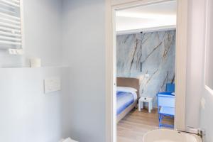 a bathroom with a mirror and a bed in a room at Casa twins in Fiumicino