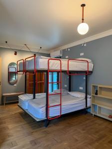 two bunk beds in a room with a ceiling at Ruby Hostel - Lux Group Dorm Rooms in Kutaisi