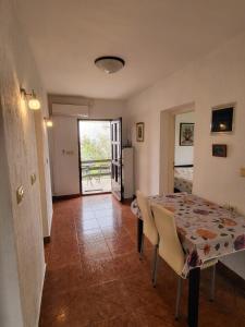 a dining room with a table and chairs and a window at Seaside Apartment Bubi in Crikvenica +33 photos