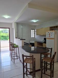 a kitchen with a table and chairs and a refrigerator at Ocean View tabatinga residence in Nísia Floresta