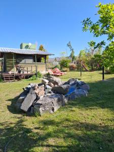 a pile of rocks in front of a house at Cabañas Casa Verde in Potrerillos +26 photos