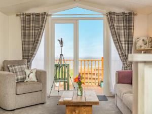 a living room with a view of the ocean at Burray in Mey