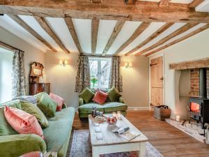 a living room with a couch and a fireplace at Hill Farm in Blyford