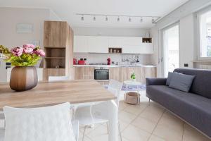 a kitchen and living room with a table and a couch at myhomEgallarate in Gallarate