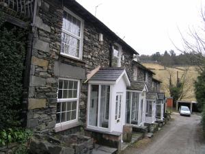 a row of windows on a stone house at Herdwick Cottage in Troutbeck Bridge +2 photos