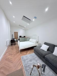 a living room with a couch and a table at Cosy Corner Cheadle in Cheadle