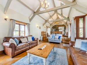 a living room with leather couches and a coffee table at Atlantic House in Bideford