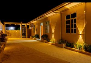 a building with lights on the side of it at night at Villaasa in Shaviyani Atoll