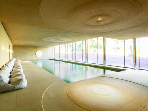 a room with a swimming pool with a bed and windows at Bell Flat - Uk42250 in Broughton