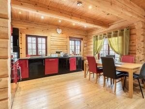 a kitchen with a table and chairs in a cabin at Ty Ceirios - Uk42100 in Carno