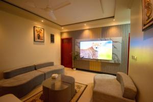 a living room with a couch and a flat screen tv at Villaasa in Shaviyani Atoll
