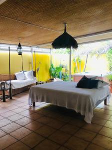 a bedroom with a large bed in a room at Joli oasis au centre de l'île in Baie-Mahault