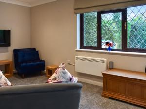 a living room with a couch and a window at Havre De Calme in Halstead