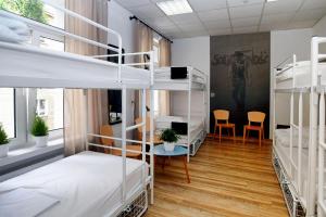 a room with a bed, chair, and a desk at Warsaw Hostel Centrum in Warsaw