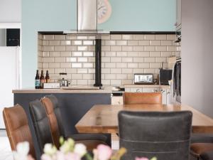 a kitchen with a wooden table and chairs at Llywnfor in Morfa Nefyn +40 photos