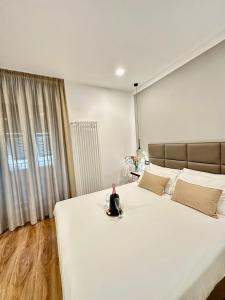 a bedroom with a large white bed with a candle on it at Sweet Rooms in La Spezia