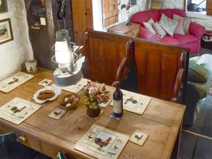 a table with a lamp and a bottle of wine at Threshing Barn - Kza in Glaisdale