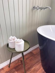 two rolls of toilet paper on a table next to a sink at Guisborough 3-Bed, with parking, Walk to Pubs, Shops & Trails in Guisborough +21 photos