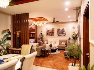 a living room with a couch and a table at MG Luxury Stays - Entire 4 BHK in Panchkula