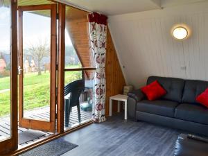 a living room with a couch and a sliding glass door at Bay View in Kingsdown