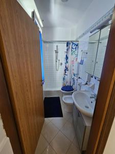 a bathroom with a toilet and a sink and a shower at Tana sul mare in Rimini