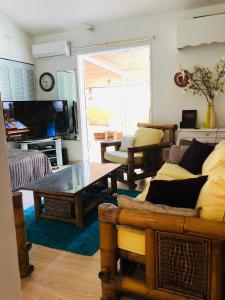 a living room with a couch and a coffee table at Joli oasis au centre de l'île in Baie-Mahault