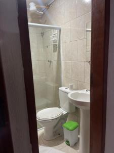 a bathroom with a toilet and a sink and a shower at Hotel Costa Rio - Conforto e Hospitalidade em Rio das ostras in Rio das Ostras +20 photos