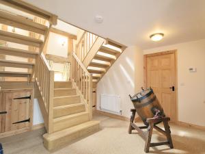 a room with wooden stairs and a wooden door at The Olde Granary - E4298 in Halston +5 photos