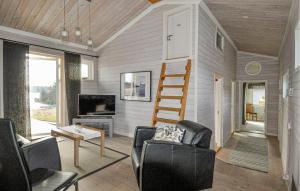 a tiny house with a ladder in a living room at 3 Bedroom Beautiful Home In Årjäng in Årjäng +21 photos