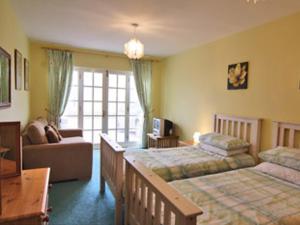 a hotel room with two beds and a couch at Pebble Cottage - Hw7447 in Broad Haven