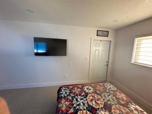 a bedroom with a bed and a flat screen tv at Miramar's Studio in Miramar